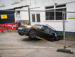 Officials still trying to figure out how to move car from sink hole