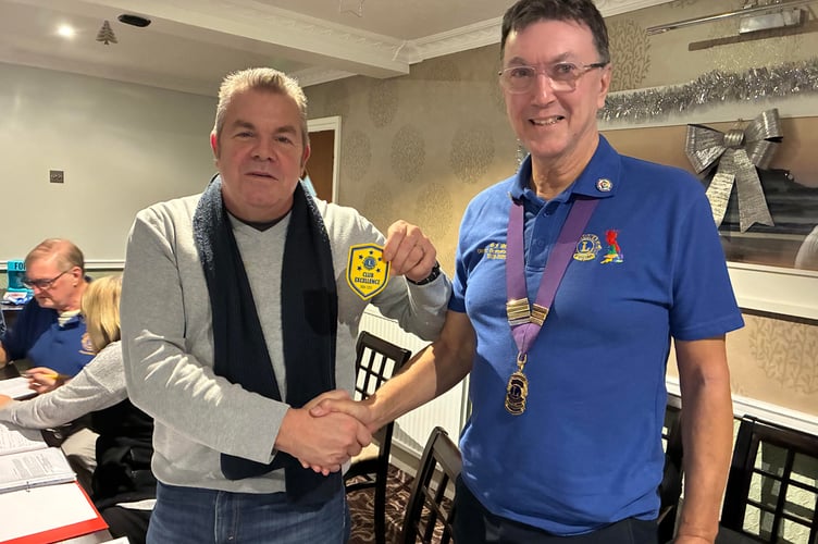 District Governor Lion Richard Allen (right) presents the award to Lion President Jon Collins at a recent Club meeting