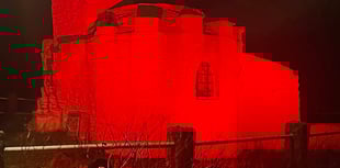 Huer’s Hut illuminated red to raise awareness