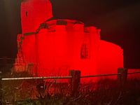 Huer’s Hut illuminated red to raise awareness