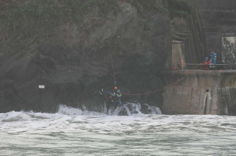 Waves crashed around the man as he was rescued (Picture: MJ Fotos)