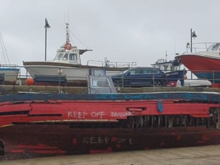 Council dismantles boat that sank in harbour
