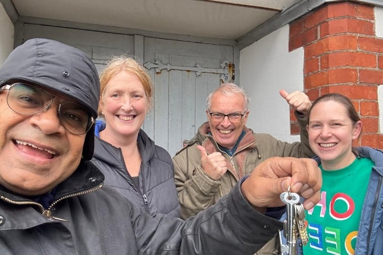 Supporters of The Zone Health and Wellbeing Hub in Downderry are all smiles after picking up the keys following their successful purchase of the former Methodist Chapel