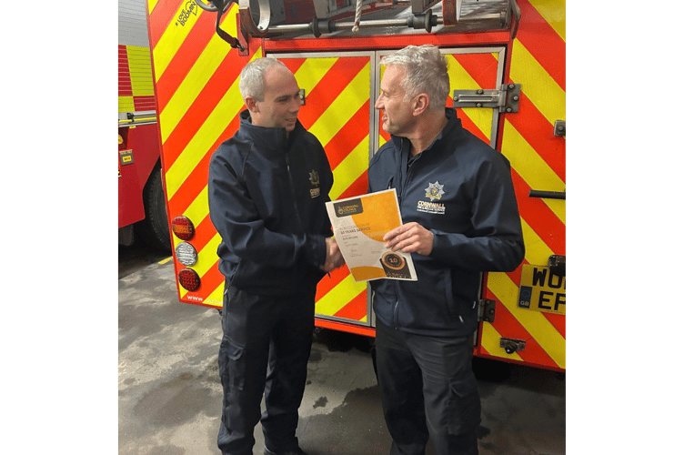 Firefighter Ahearn (left), being presented with the award at Bodmin Community Fire Station (Picture: CFRS)