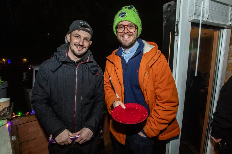 Vicar of St Austell the Rev Jonathan Huff (green wooly hat) with a resident.