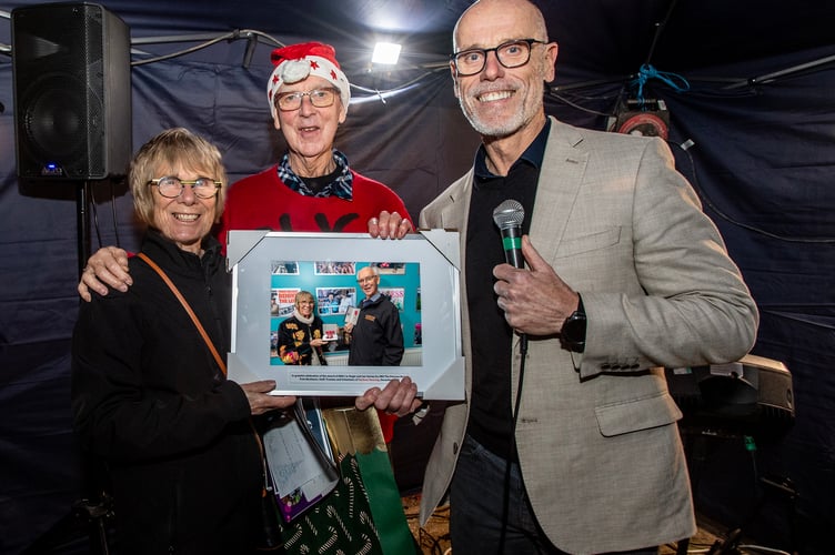 Roger and Jan Varney receive a framed portrait from Harbour Housing trustee Tim Styles.