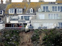 Apartment complex left in precarious position following rockfall