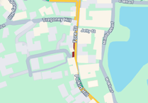 Road closed both ways after car collides with wall