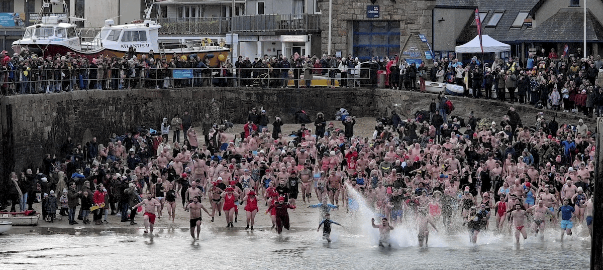Swimmers take part in traditional New Year’s Day dip for charity ...