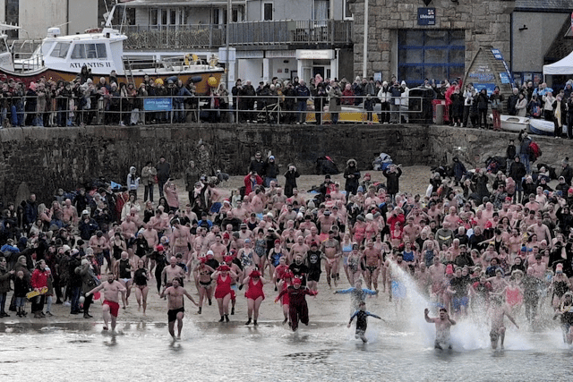 Swimmers take part in traditional New Year’s Day dip for charity