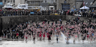 Swimmers take part in traditional New Year’s Day dip for charity