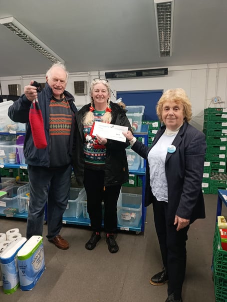 Local Voice Reform UK represetatives hand over a check to Mandy May of Truro Foodbank