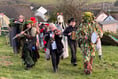 Traditional wassail takes place in orchard looking over coast