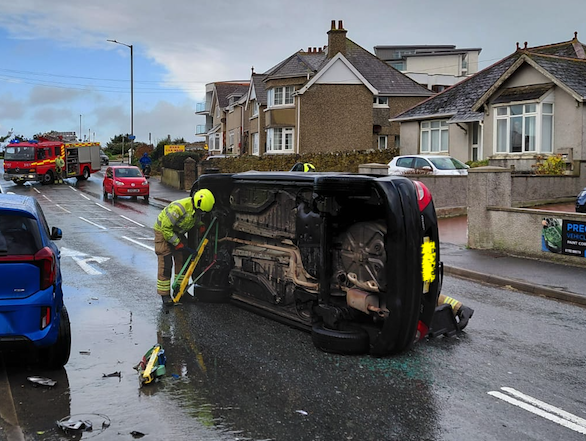 A car rolled onto its side following the collision (Picture: Warren Wilkins)