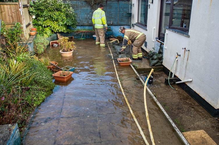 Recurring serious flooding at Springfield Road, Goldsithney near Penzance today (Sunday.) Fire officers in the flooded garden of the house where the flow is estimated at approximately 1,000 litres per minute. Picture by Colin Higgs
