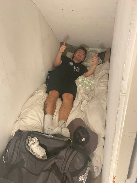 Liam Gardener living in the cupboard under the stairs. A man paid £200 per month to live in a shoe cupboard after being unable to find a sublet in Bristol. Liam Gardener, 26, was planning a move to Australia in June 2024 when the tenancy at his old flat ran out. To earn some extra cash to put towards his travels set to begin in January 2025, Liam was keen to stay living and working in Bristol, Somerset, in his commission-based recruitment job. Down on his luck in finding a suitable sublet to see him through his five-month stint, a co-worker offered up her shoe cupboard for Liam to stay in. 
