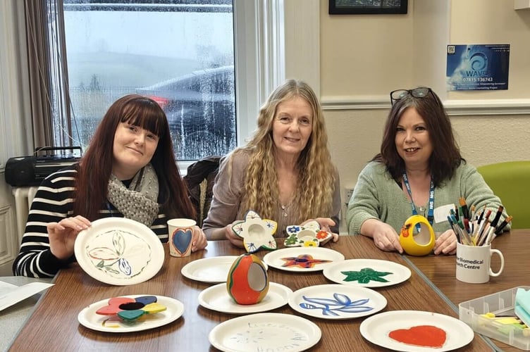 Pictured (left to right): Molly Martin, Julia Mason and Nicky Snape, with butterfly and bird feeders, made by those who have attended Nature for Health sessions