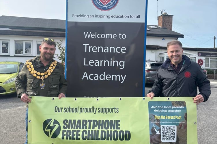 (L-R) Mayor Drew Creek presents the smart phone free banner to Trenance Learning Academy head teacher Matt Williams (Picture: Newquay Town Council)