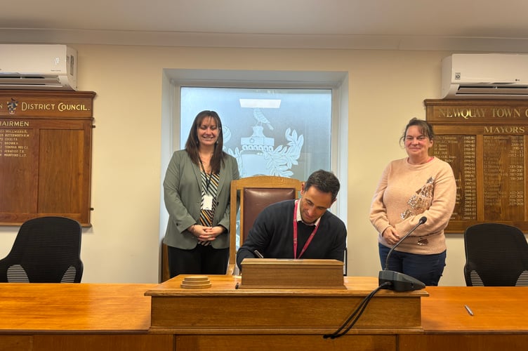 Newquay Junior Academy assistant headteacher Ryan Doble signs the smart phone agreement (Picture: Newquay Town Council)