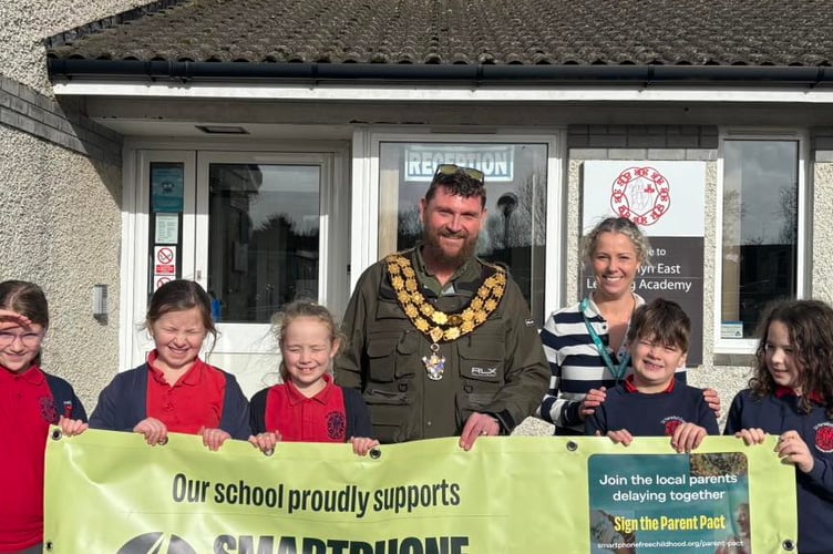 Mayor Drew Creek delivering the smartphone free banner to St Newlyn East Academy (Picture: Newquay Town Council)
