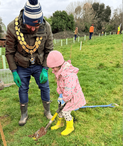 Mayor Drew Creek was helped by his daughter Beatrice plant saplings
