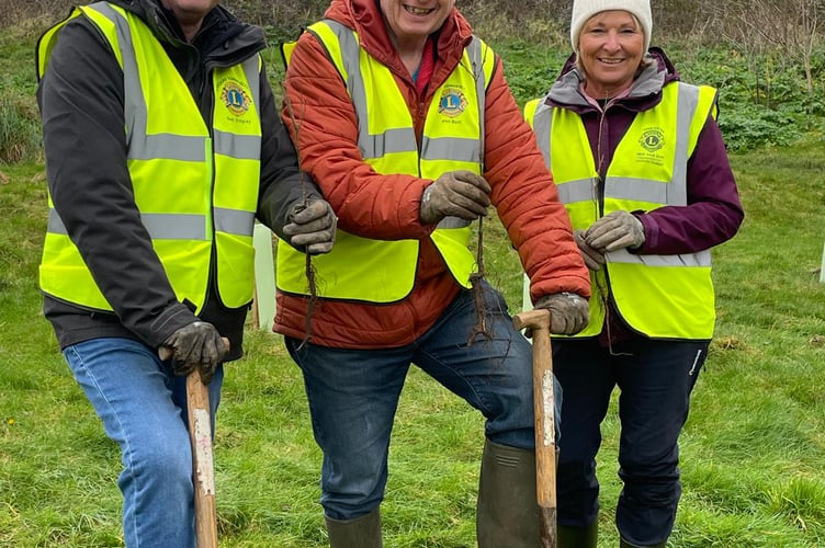Members of Newquay Towna Blystra Lions digging deep to help out