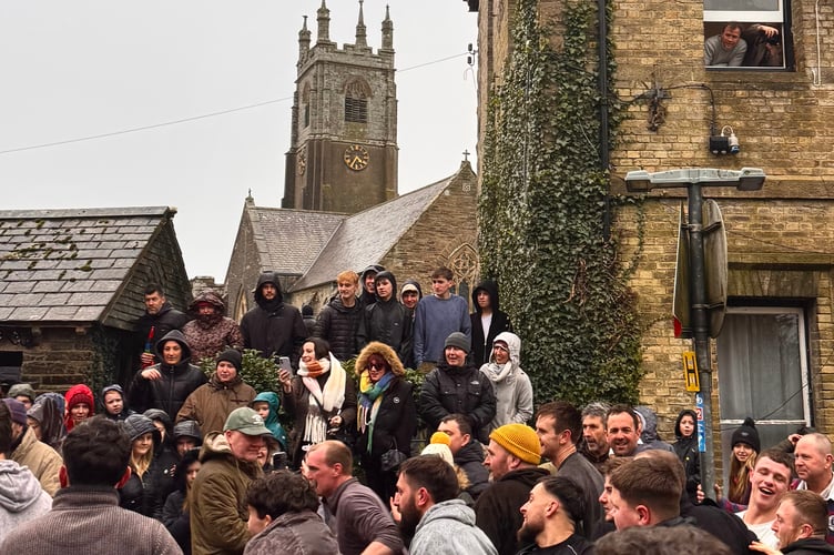 Hurlers get close to the spectators in front of the parish church