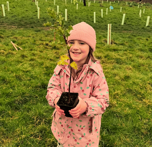Beatrice Creek with one of the saplings she helped to plant