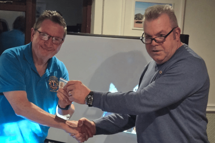 (L-R) Lion Phil Bunt receiving the Builder Key award from Towan Blystra Lions president Jon Collins