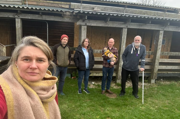 Jayne Kirkham MP at Trelander Communuty Centre with Cllr Loic Rich (holding dog) and committee members including Lorraine Vinson (second from left)