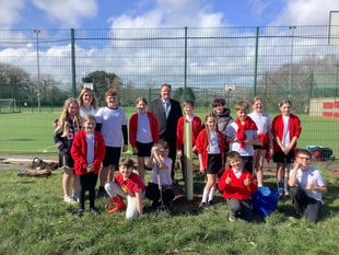Pupils help to plant trees at primary school