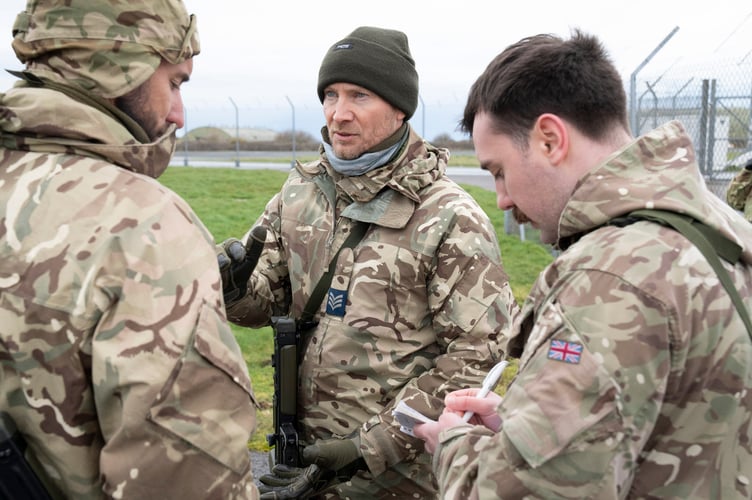 Personnel working together to conduct vehicles checks (Picture: Cpl  Martin Davis RAF)