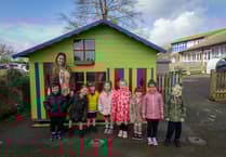 Volunteers bring fun to Looe Primary with refurbished playhouse