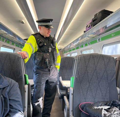 Sergeant Gary Smith aboard a train as police set out to tackle county lines with high-visibility police patrols