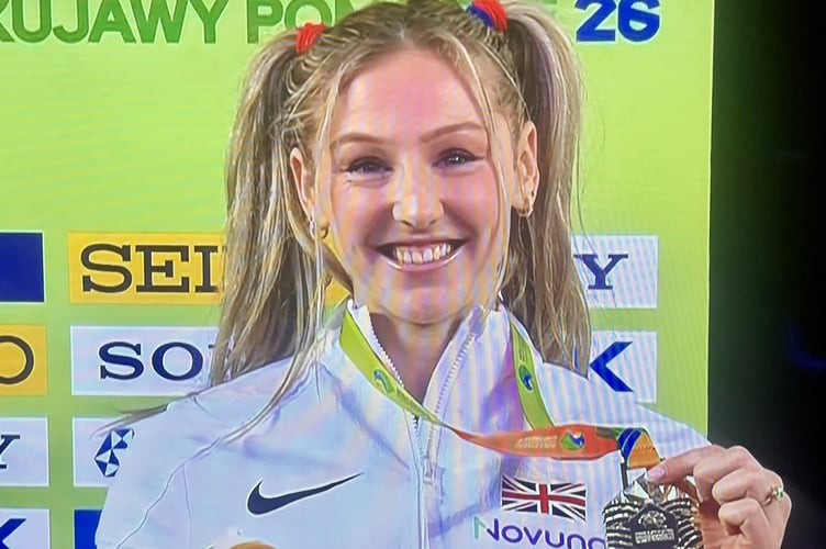 Cornwall's Molly Caudery celebrates winning gold at the World Athletics Indoor Championships in Torun, Poland