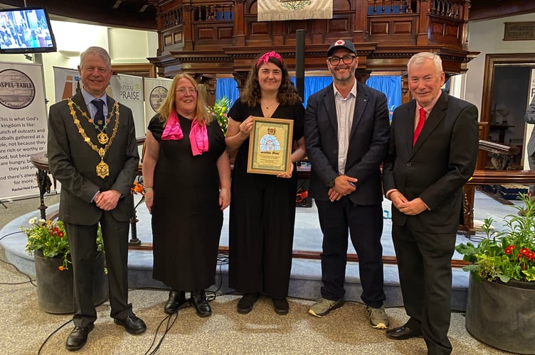 Representatives from the Friends of Daubuz Moor collect a Truro Civic Award from city mayor Cllr Chris Wells (left) and Truro Civic Society chairman Malcolm Bell (right)