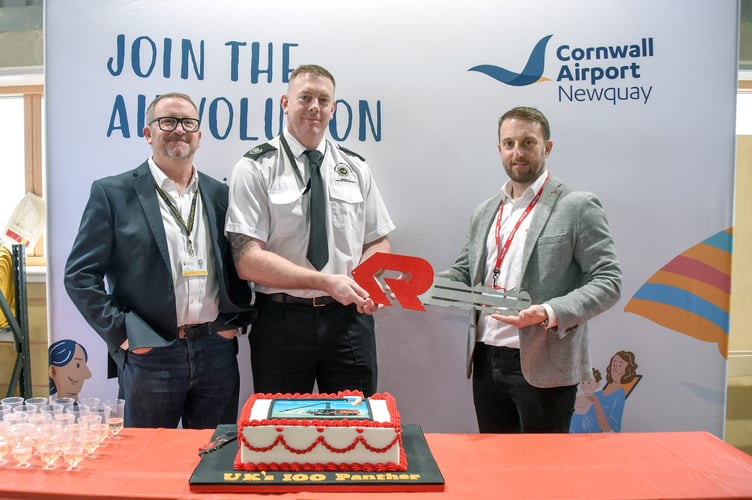 (L-R) Cornwall Council Cabinet member Tim Dwelly, Charles Dixon and  Ian Robertshaw, Rosenbauer cut a cake to celebrate the delivery of the new fire trucks