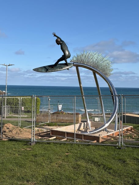 The scaffolding has been removed from the surf statue