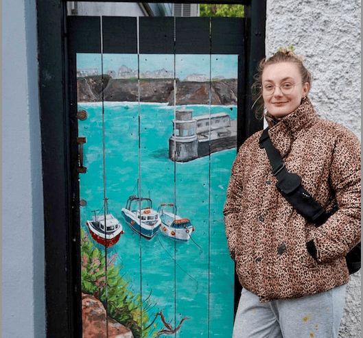 Newquay Harbour 2025 by Gemma Carson. Newquay Harbour at its finest — sunlit Cornish waters, bobbing boats, jellyfish and clifftop wildflowers, painted in a traditional style as a heartfelt homage