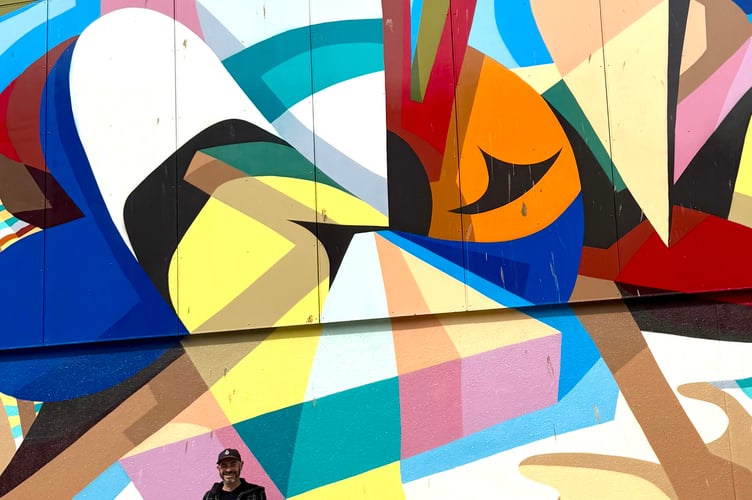 Newquay BID manager Mark Warren with one of the Love Newquay murals