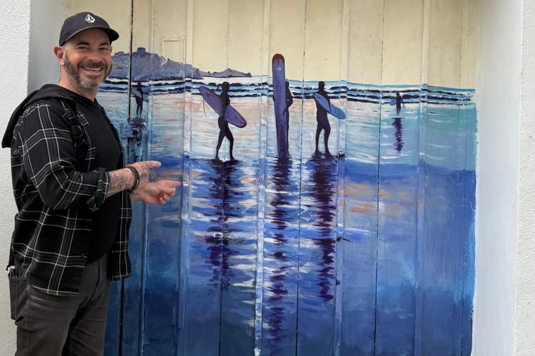 Newquay BID manager Mark Warren with a Love Newquay mural created by Ian Fox