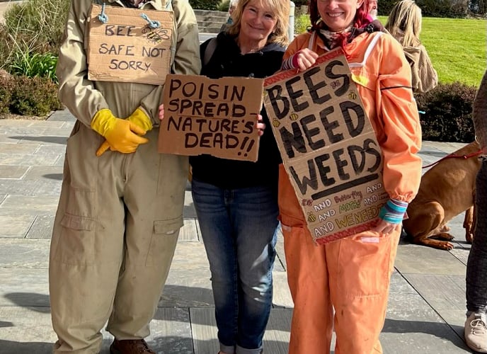 Protest banners included “Poison spread-nature’s dead” and “Bee the solution Save Nature”