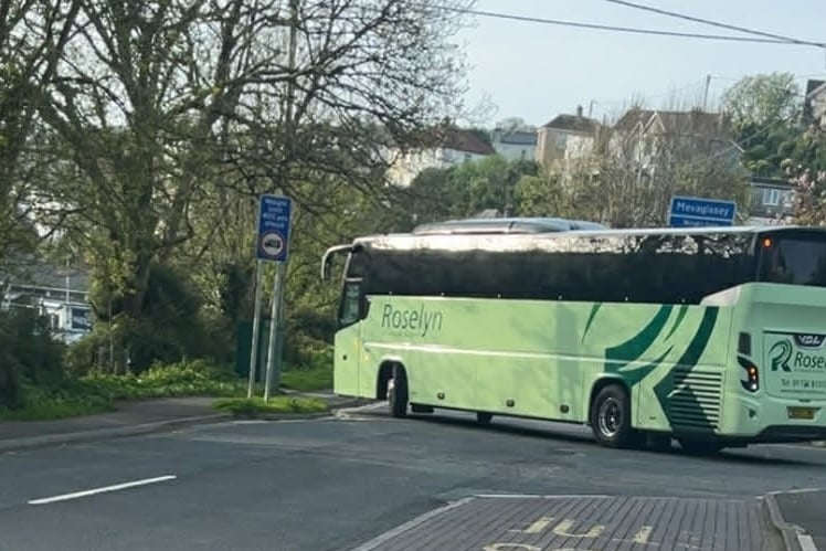 A school bus leaves Mevagissey heading for St Austell.