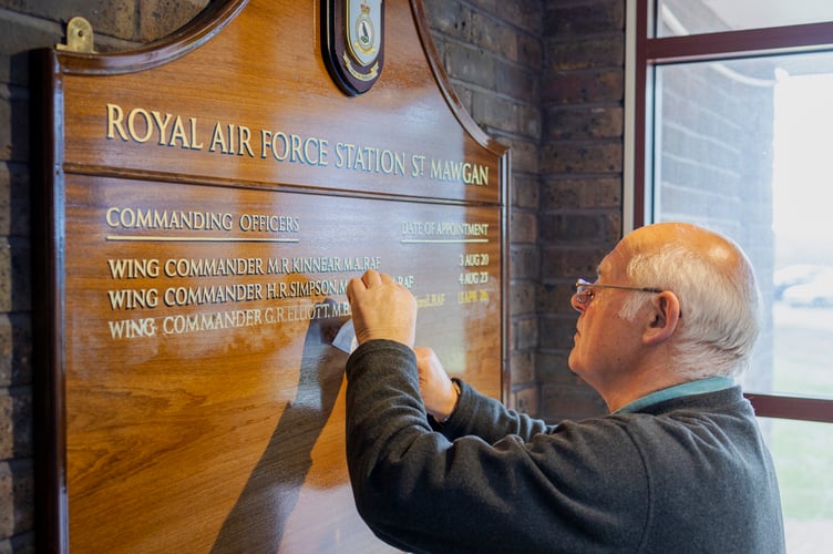 Images of  the David Dunkley, Director of Parc Signs, hand painting the name of incoming Station Commander, Wing Commander Gareth Elliot, onto the command board. Mr Dunkley has personally added the name of every Station Commander to the board since 1982. 
