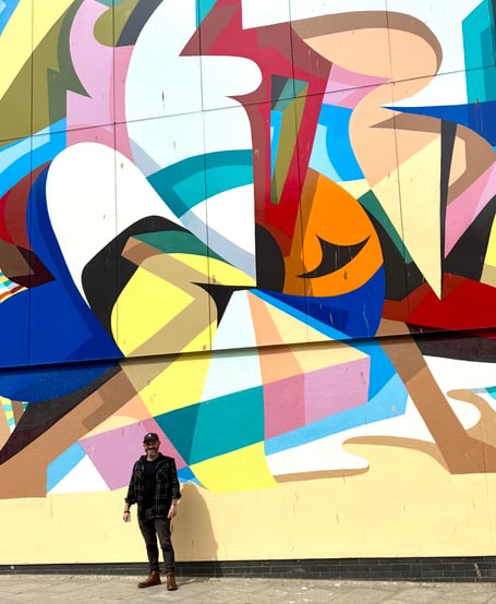 Mark Warren in front of the mural at MIX NQY