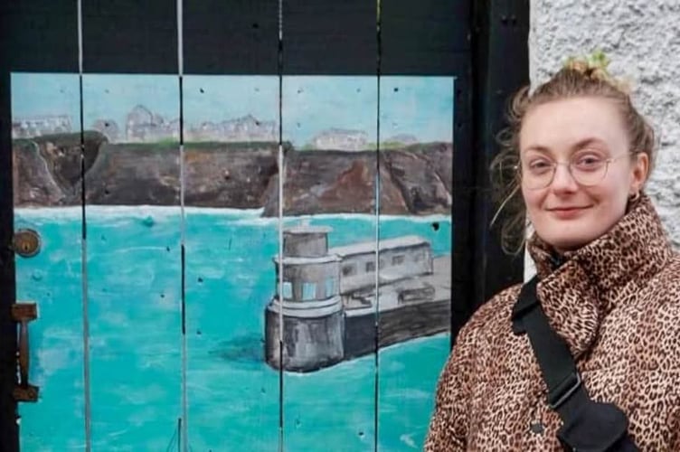 Gemma Carson alongside her Newquay Harbour mural in Fore Street