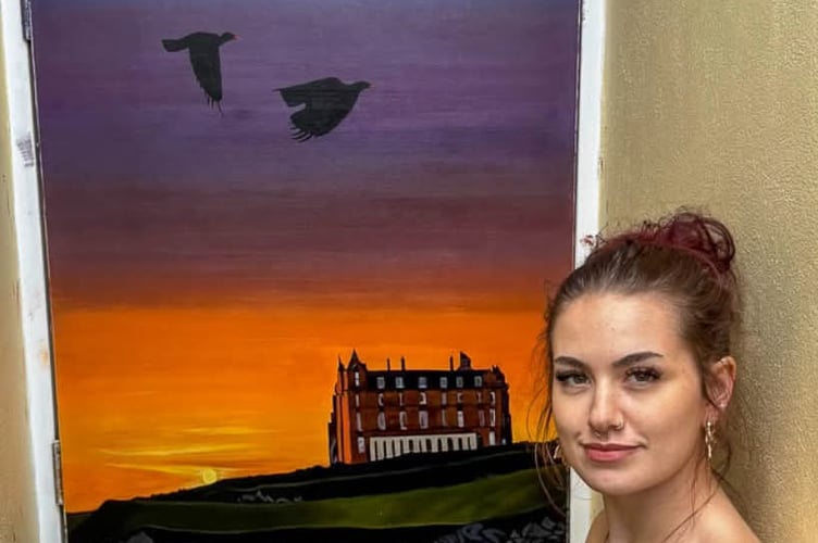 Saskia Taskis with her painting Sunset at the Headland