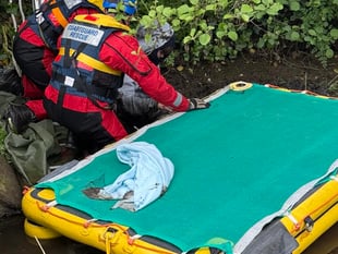 Man stuck up to his waist in mud