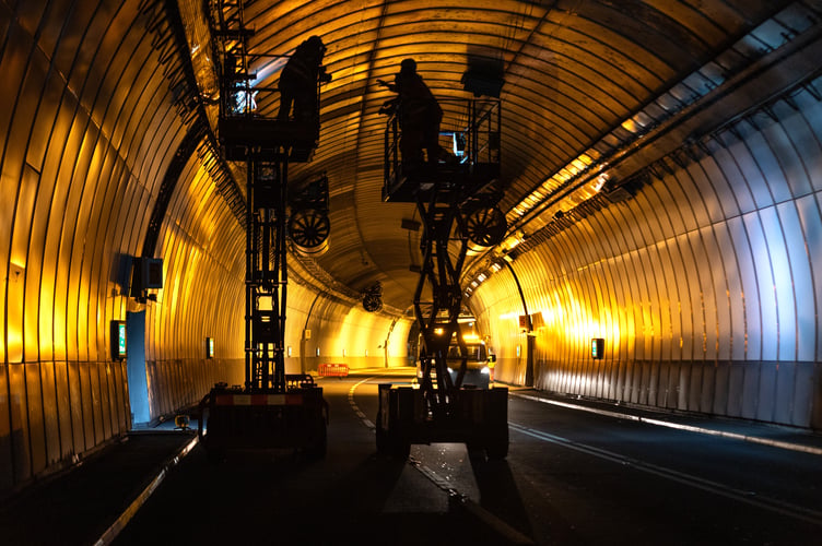 Teams working overnight to install and connect new LED lighting systems in the tunnel