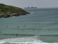 Huge aircraft carrier looms out of the mizzle in Newquay Bay